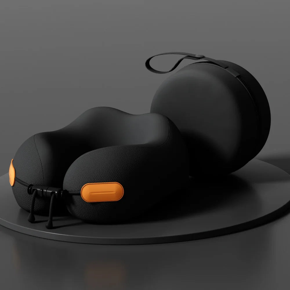 Black travel neck pillow with orange accents on a dark gray background