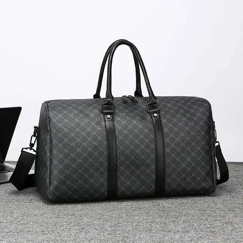 Gray patterned duffel bag with black straps on a light gray surface.