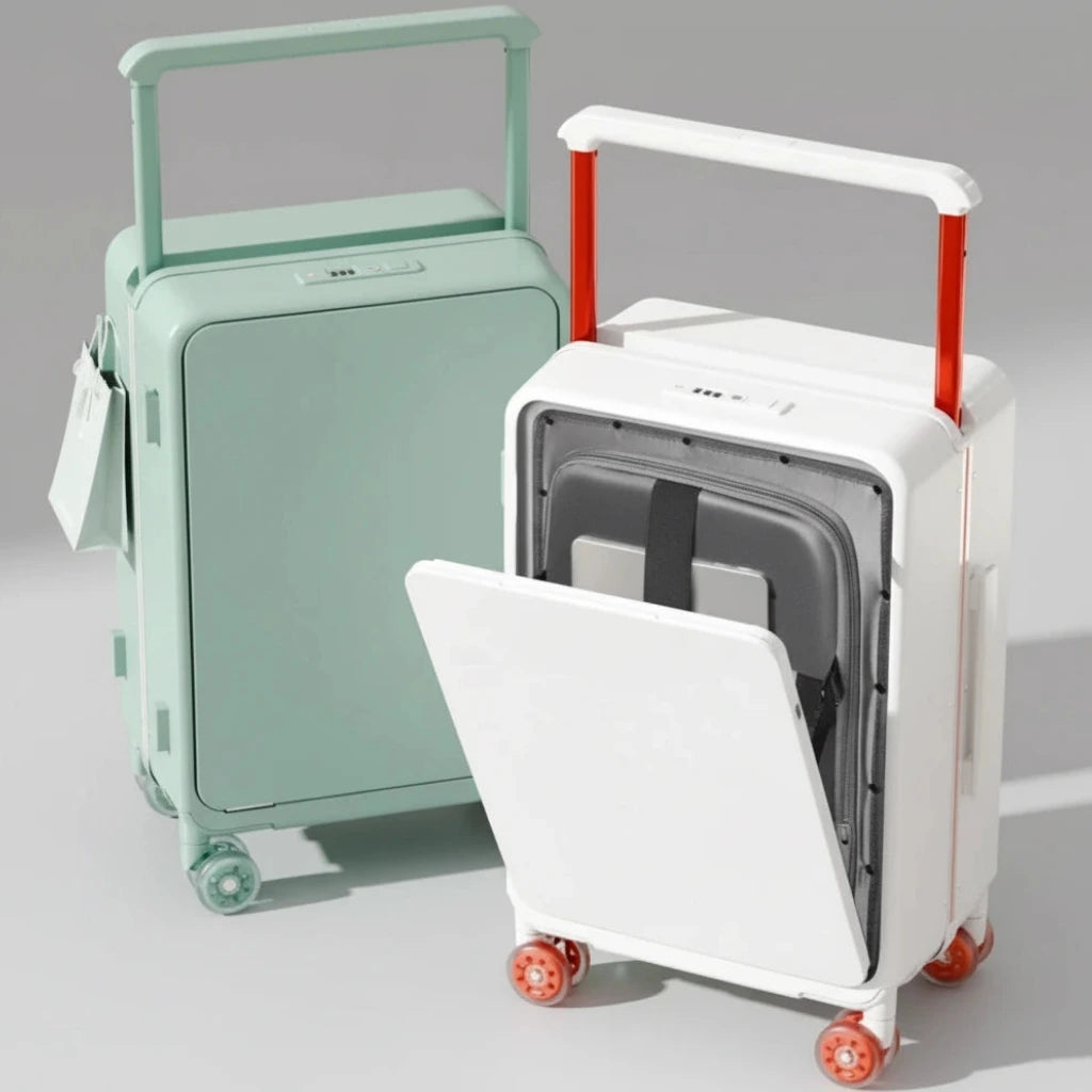 Two suitcases, one green and one white with red handles, on a wooden floor.
