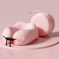 Pink travel neck pillow with carrying case on a pink background