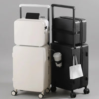Set of stacked suitcases with a black and white color scheme on a wooden floor.